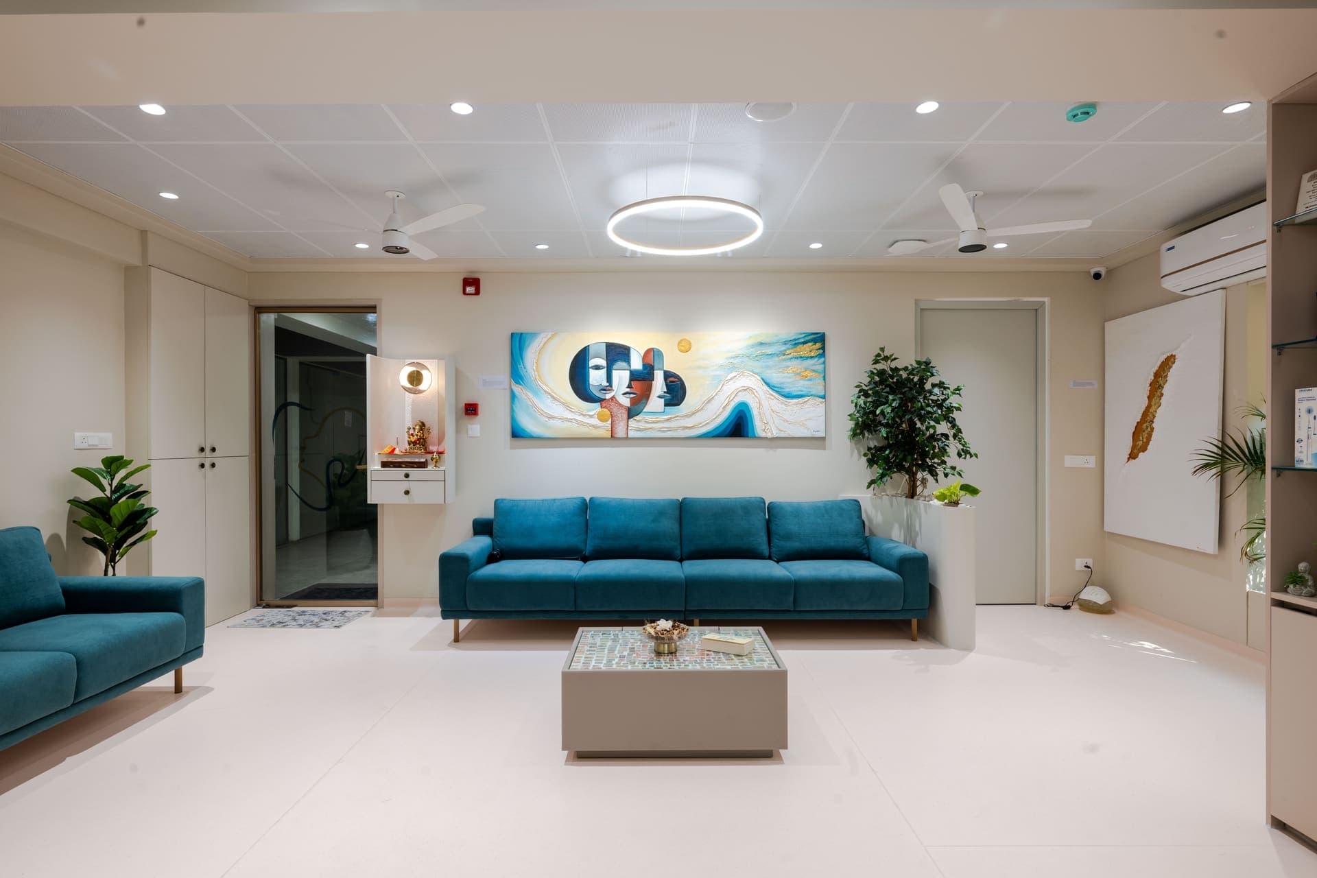 Bright lounge interior with teal seating at Aurevo Dental Hospital